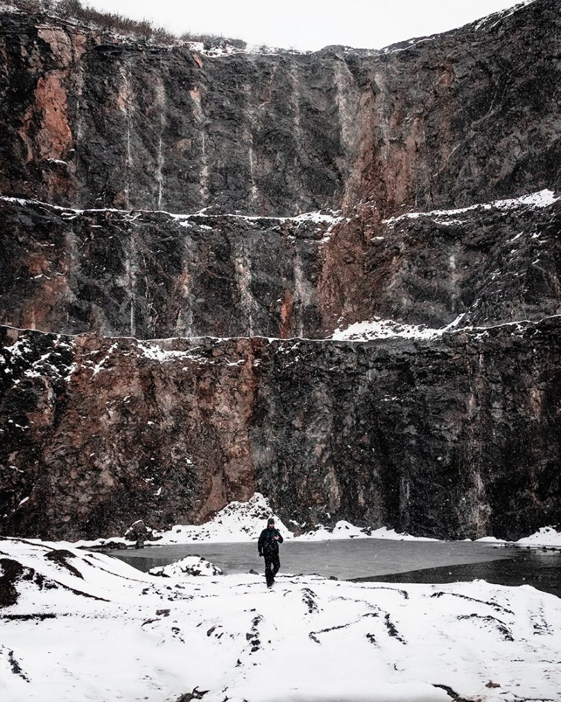 Man walking alone in frozen landscape
